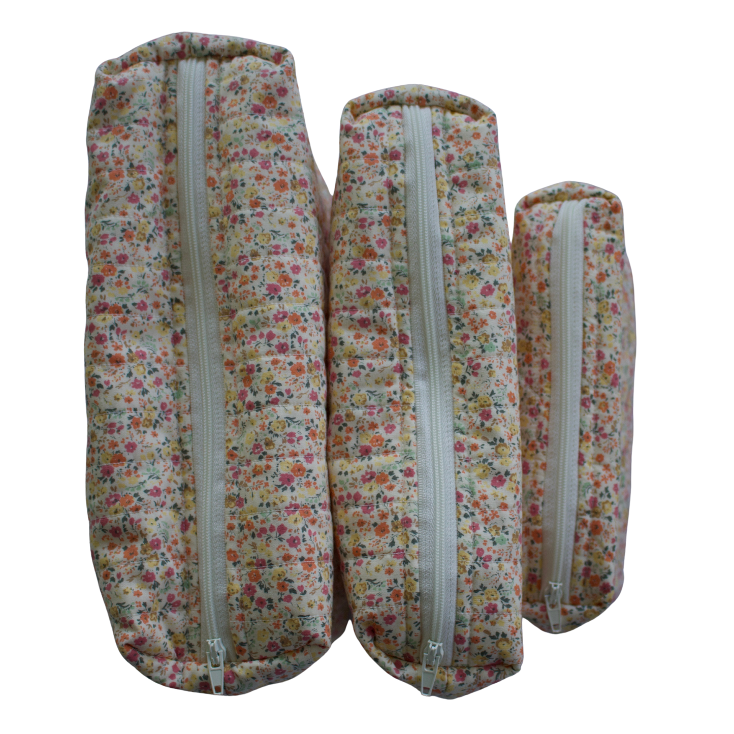 Three floral-patterned fabric rolls with zippers on a white background mini pouch beauty pouch travel pouch