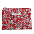 Floral patterned pouch with 'Kitt Designs' label zipper pouch