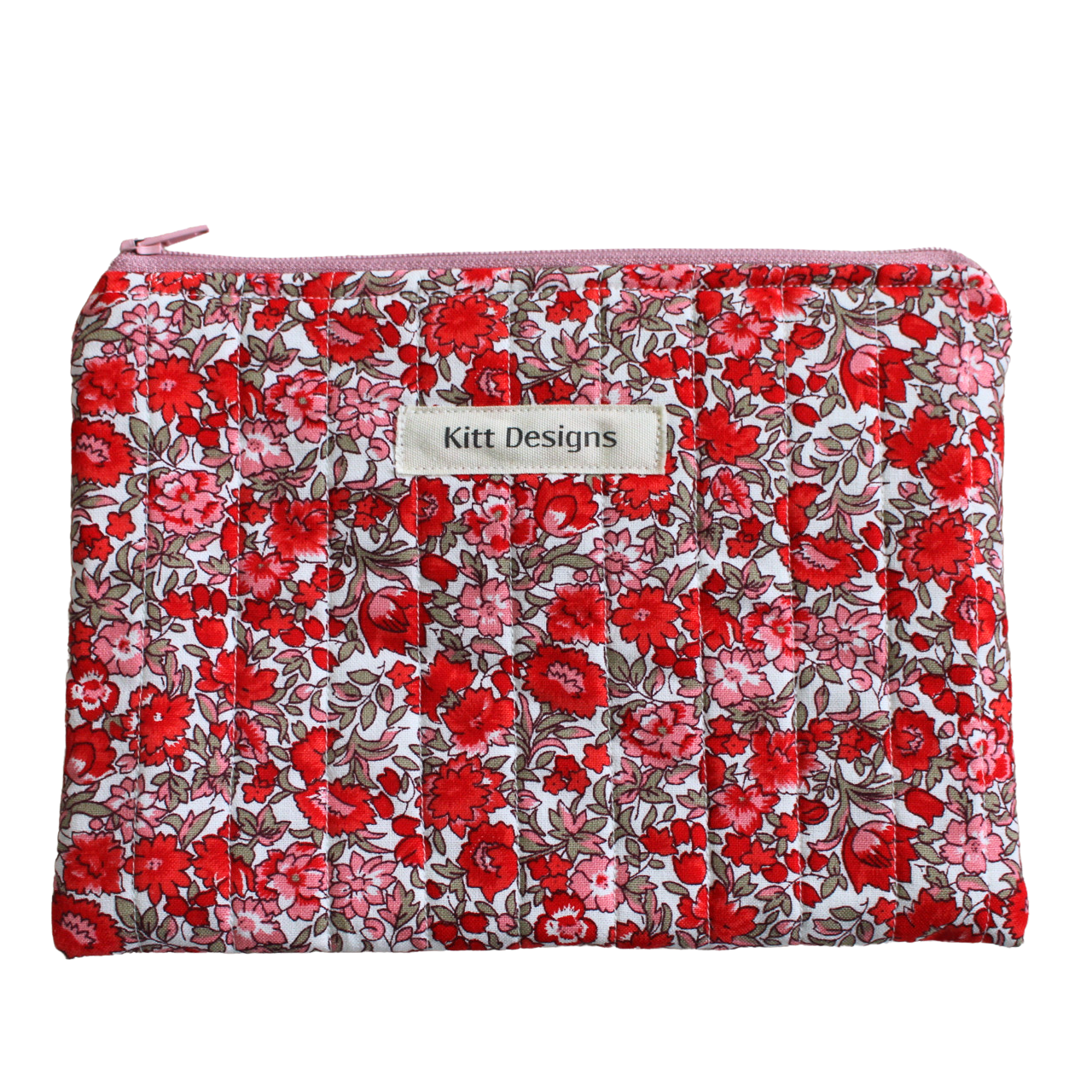 Floral patterned pouch with 'Kitt Designs' label zipper pouch