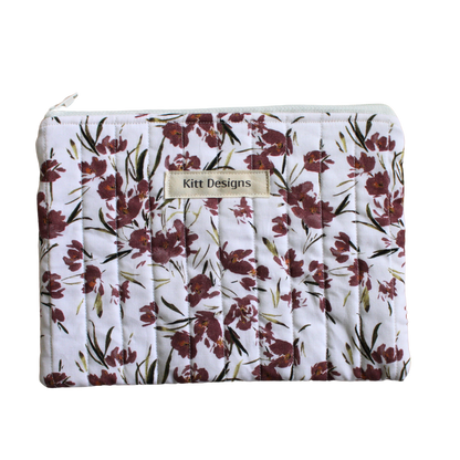 Floral-patterned pouch with 'Kitt Designs' branding zipper pouch
