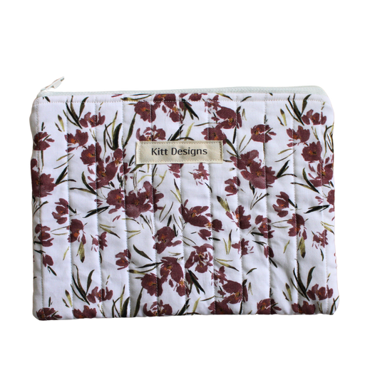 Floral-patterned pouch with 'Kitt Designs' branding zipper pouch