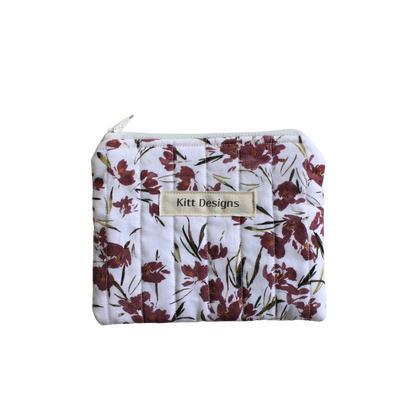 Floral-patterned pouch with 'Kitt Designs' label coin pouch