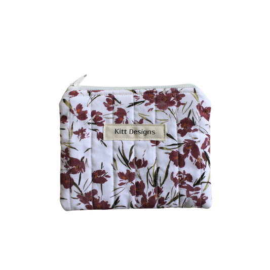 Floral-patterned pouch with 'Kitt Designs' label coin pouch