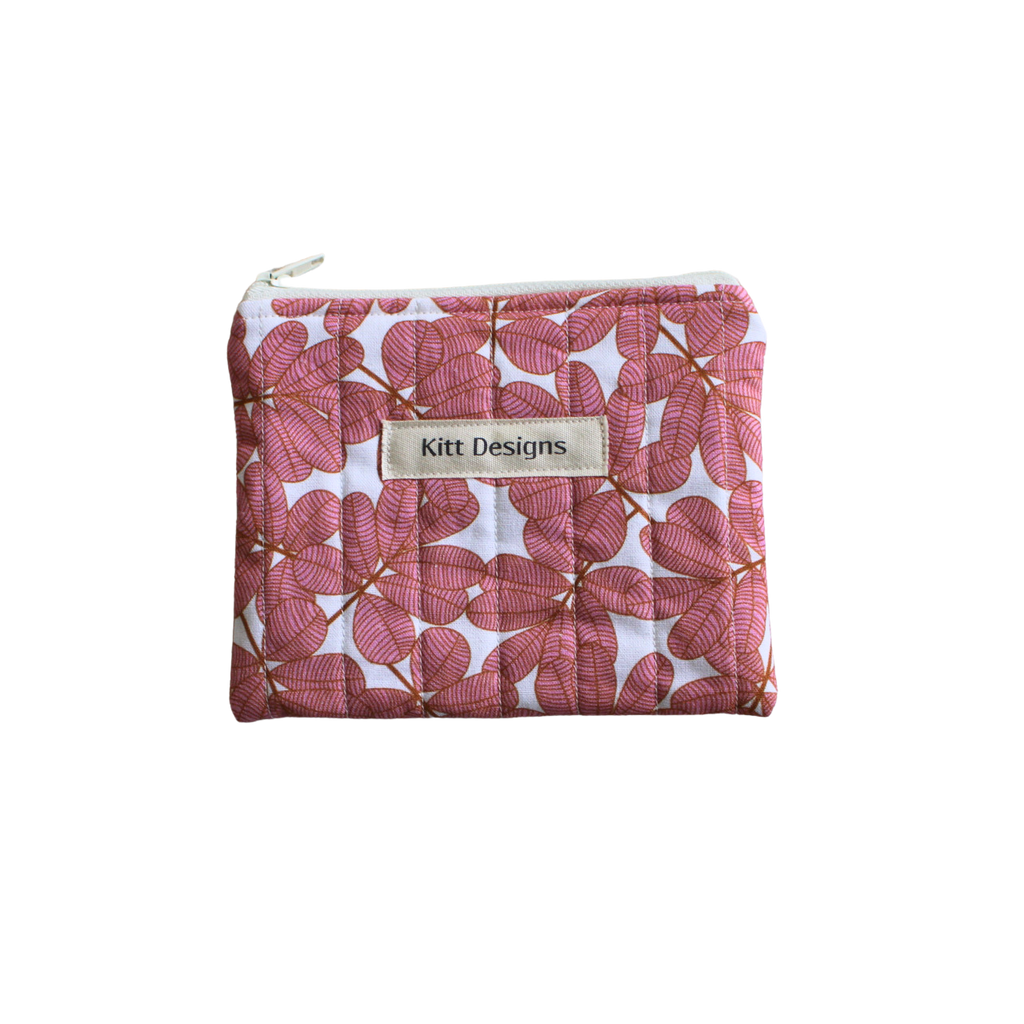 Pink floral pouch with 'Kitt Designs' label coin pouch