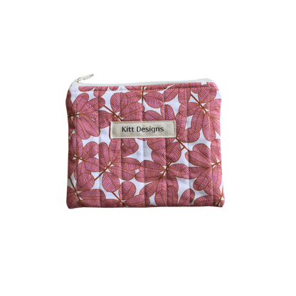 Pink floral pouch with 'Kitt Designs' label coin pouch