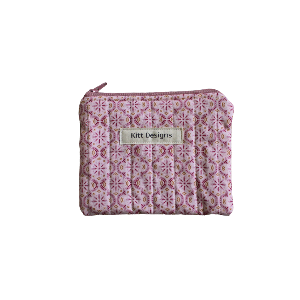 Small pink patterned pouch with a brand label coin pouch