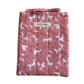 Pink floral-patterned product with a brand label small book sleeve