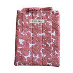 Pink floral-patterned product with a brand label small book sleeve