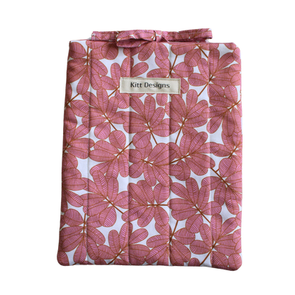 Pink floral-patterned product with a brand label small book sleeve