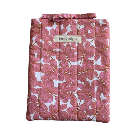 Pink floral-patterned product with a brand label small book sleeve