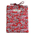 Floral-patterned fabric roll with a visible brand label small book sleeve