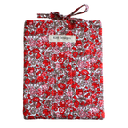 Floral-patterned fabric roll with a visible brand label small book sleeve