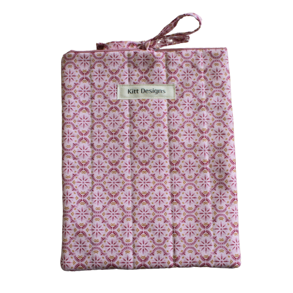 Patterned fabric package with 'Kitt Designs' branding small book sleeve