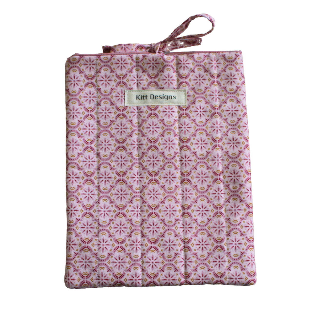 Patterned fabric package with 'Kitt Designs' branding small book sleeve
