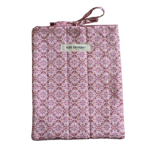 Patterned fabric package with 'Kitt Designs' branding small book sleeve