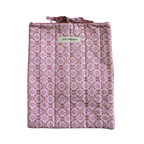 Pink patterned bag with a visible brand label large book sleeve