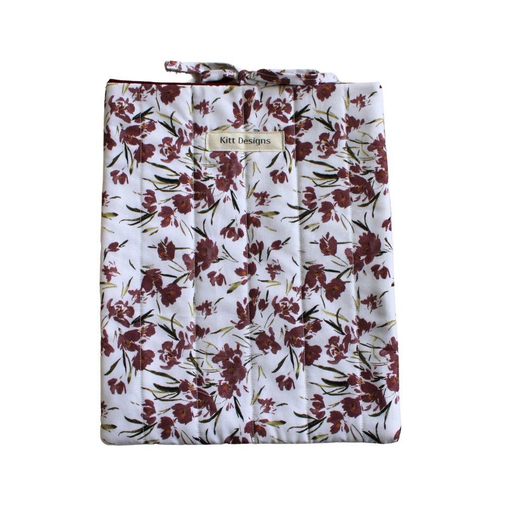 Floral-patterned bag with a visible brand label large book sleeve