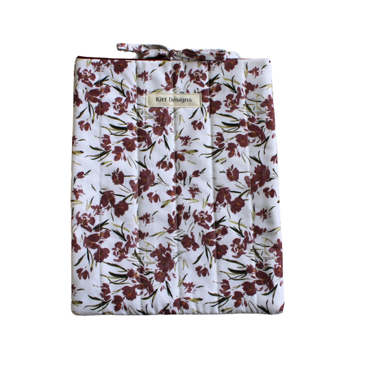Floral-patterned bag with a visible brand label large book sleeve