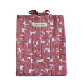 Pink floral-patterned quilt with a brand label large book sleeve