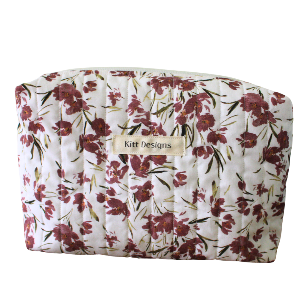 Floral-patterned pouch with 'Kitt Designs' label beauty pouch