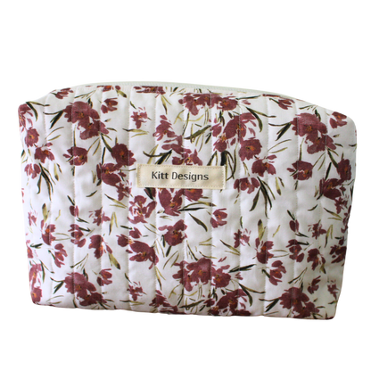 Floral-patterned pouch with 'Kitt Designs' label beauty pouch