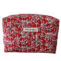 Floral-patterned makeup bag with 'Kitt Designs' label beauty pouch