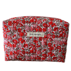 Floral-patterned makeup bag with 'Kitt Designs' label beauty pouch