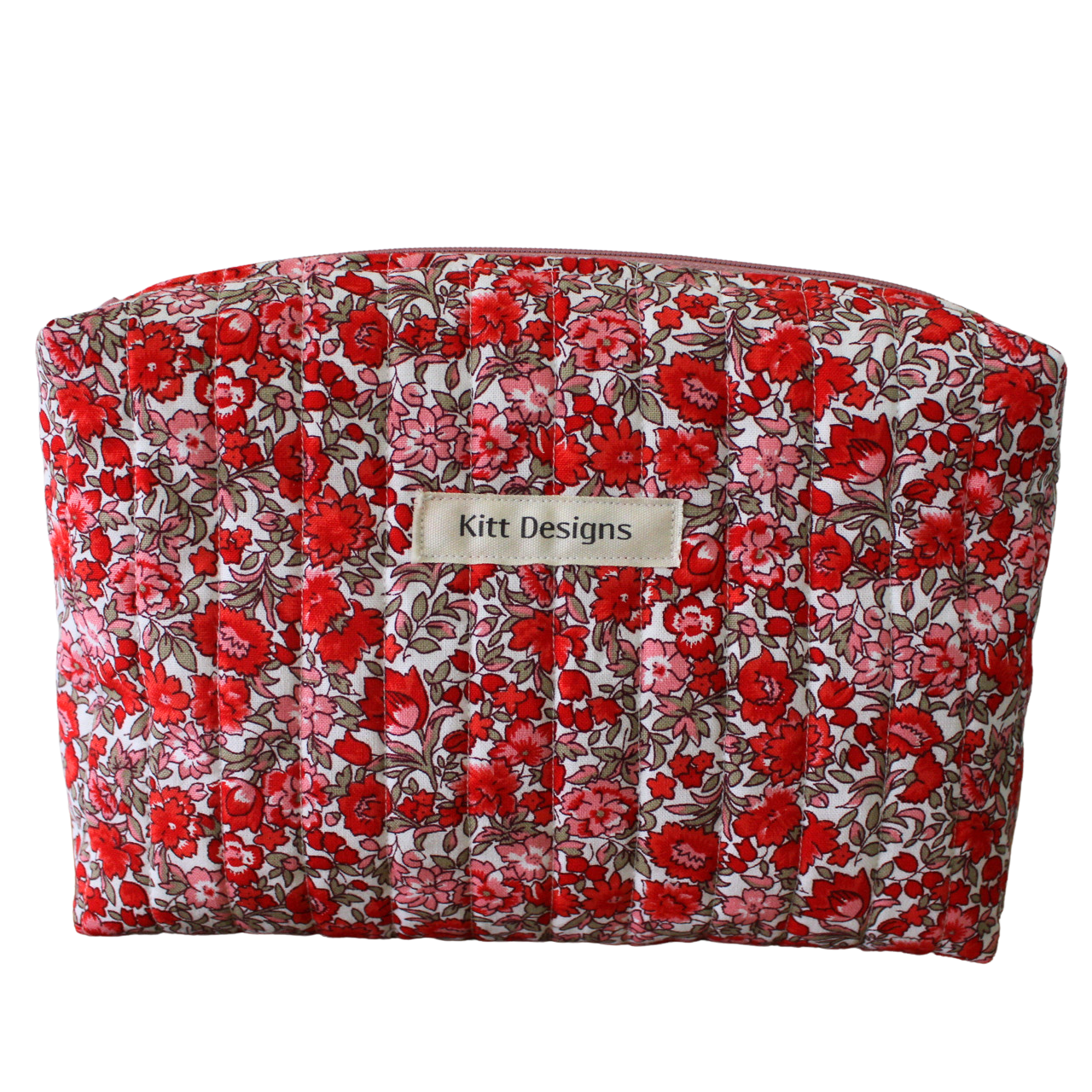 Floral-patterned makeup bag with 'Kitt Designs' label beauty pouch