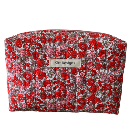 Floral-patterned makeup bag with 'Kitt Designs' label beauty pouch
