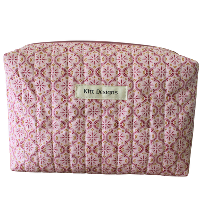 Patterned pouch with 'Kitt Designs' label beauty pouch