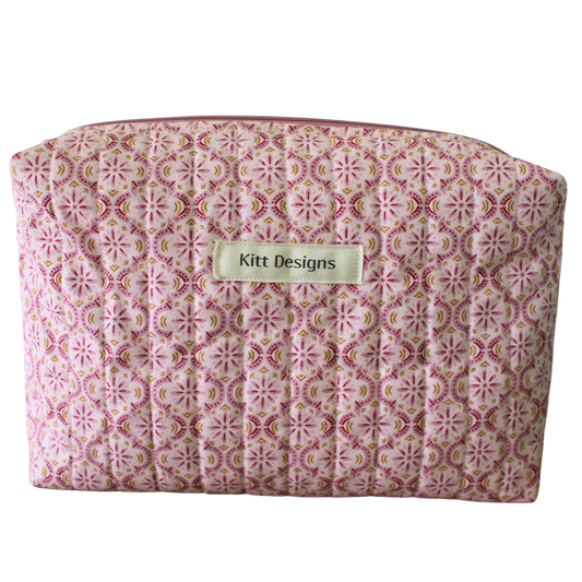 Patterned pouch with 'Kitt Designs' label beauty pouch