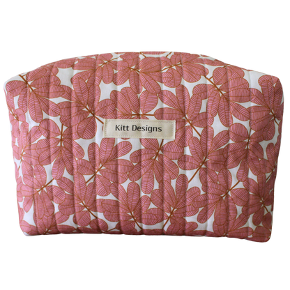 Pink floral-patterned pouch with 'Kitt Designs' label travel pouch