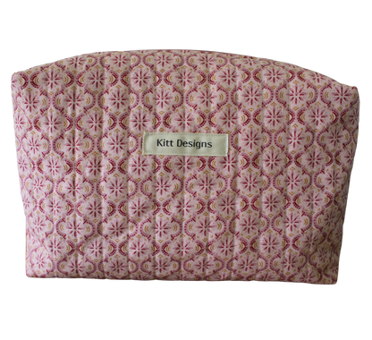 Patterned pouch with 'Kitt Designs' label travel pouch