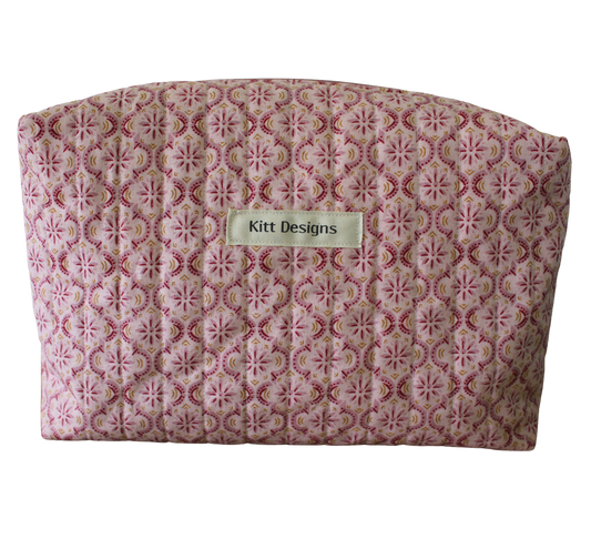 Patterned pouch with 'Kitt Designs' label travel pouch