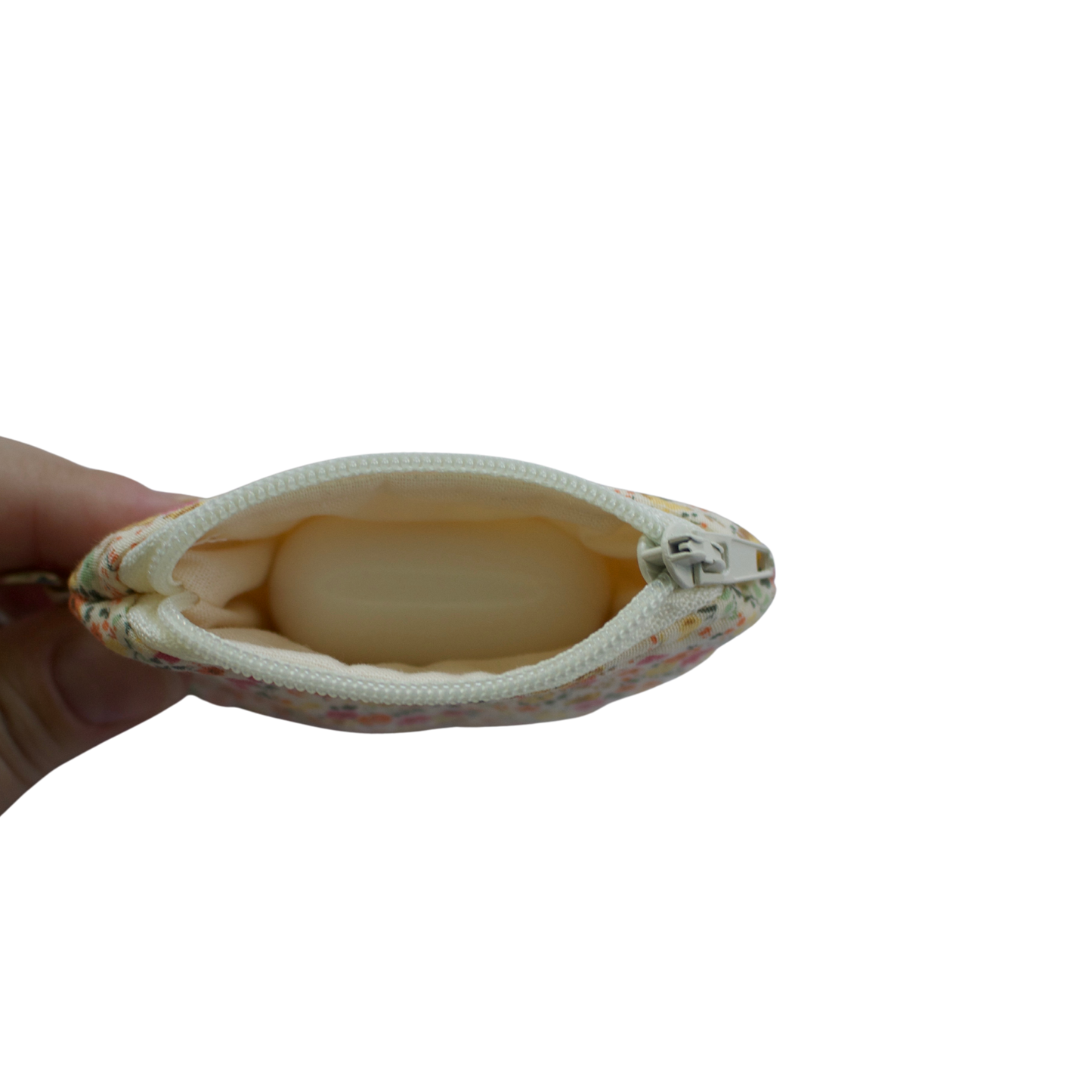 Small pouch held by a hand on a white background