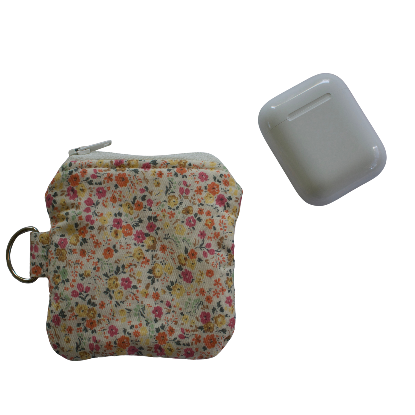 Floral-patterned pouch with a keychain and a small rectangular item on a white background