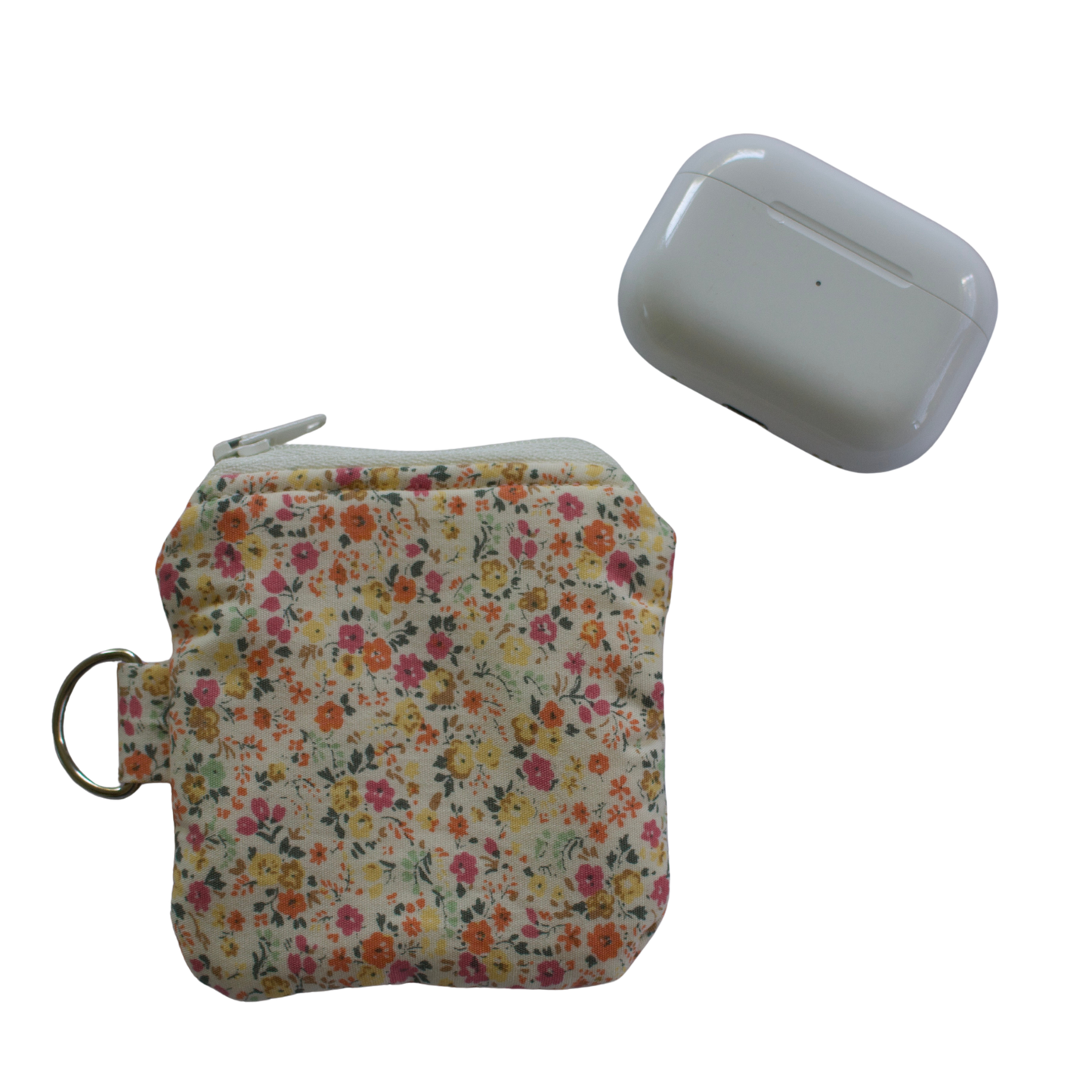 Floral-patterned pouch and white device on a white background