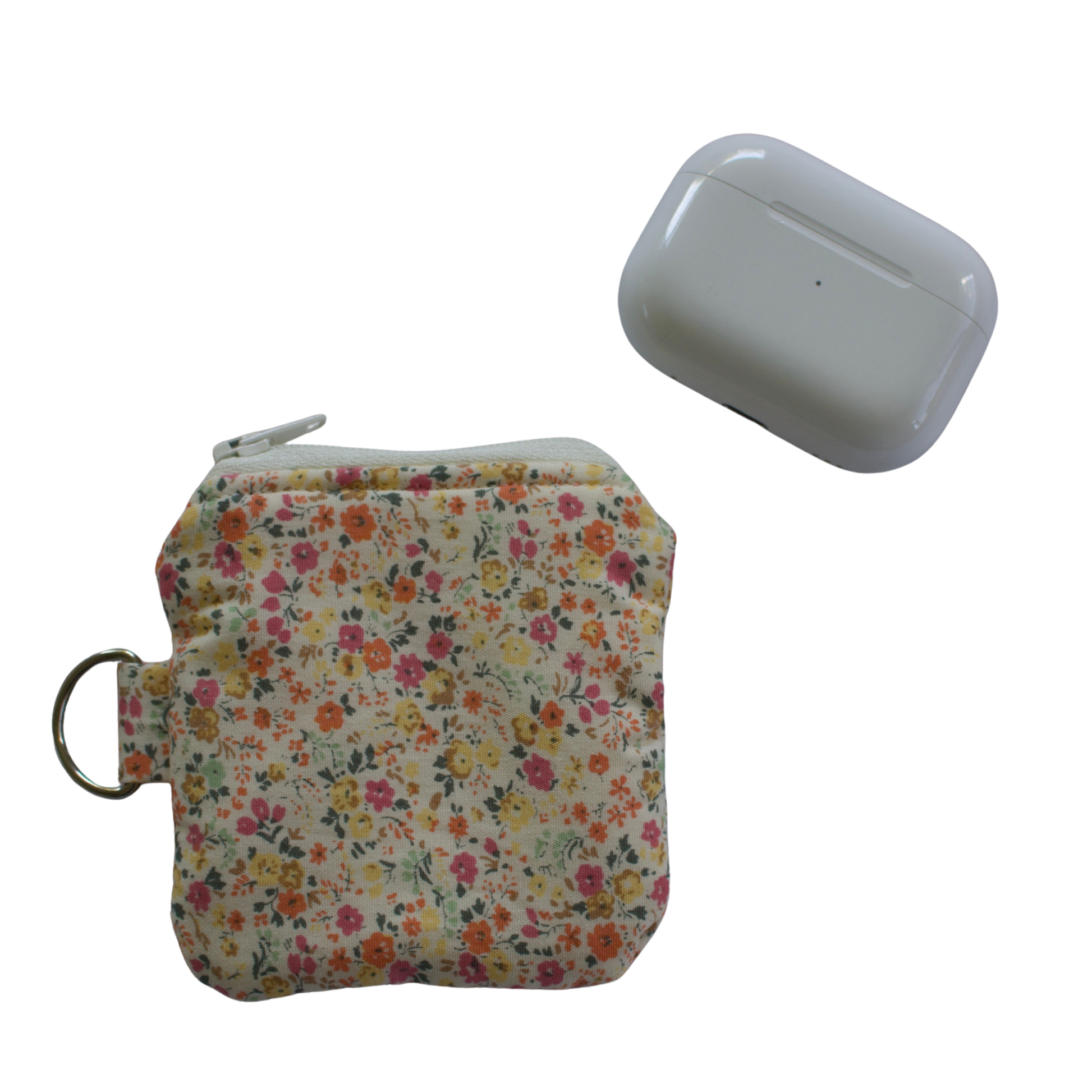 Floral-patterned pouch and white device on a white background