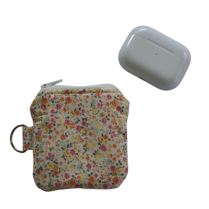 Floral-patterned pouch and white device on a white background