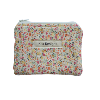 Floral patterned pouch with 'Kitt Designs' label coin pouch coin purse