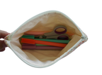 Pouch with colorful items including scissors and straws on a white background zipper pouch