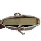 Fabric pouch with a book inside on a white background small book sleeve