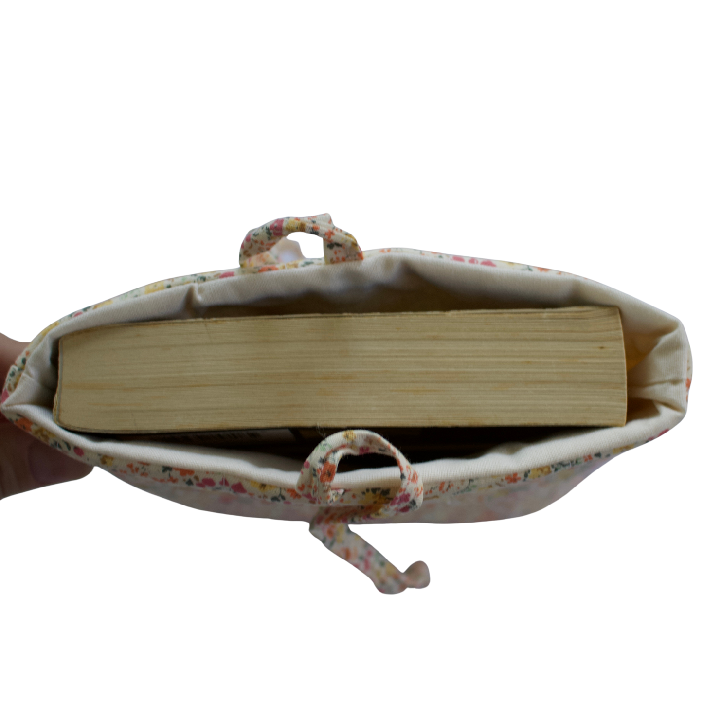 Fabric pouch with a book inside on a white background small book sleeve