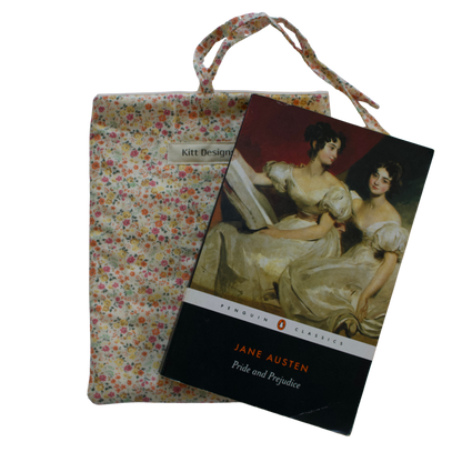 Book cover of 'Pride and Prejudice' by Jane Austen with a floral fabric pouch on a white background small book sleeve