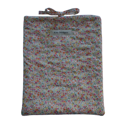 Floral-patterned pouch with a strap on a white background for books