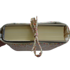 fabric book with a floral ribbon on a white background book sleeve