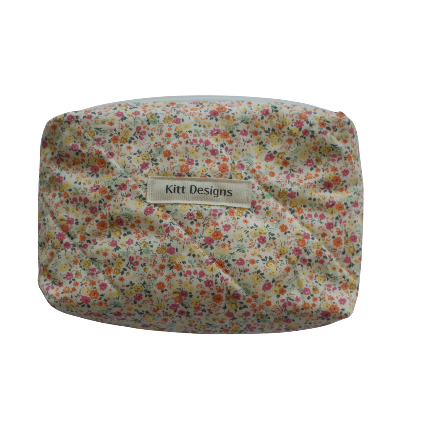 Floral patterned pouch with 'Kitt Designs' label on a white background mini pouch