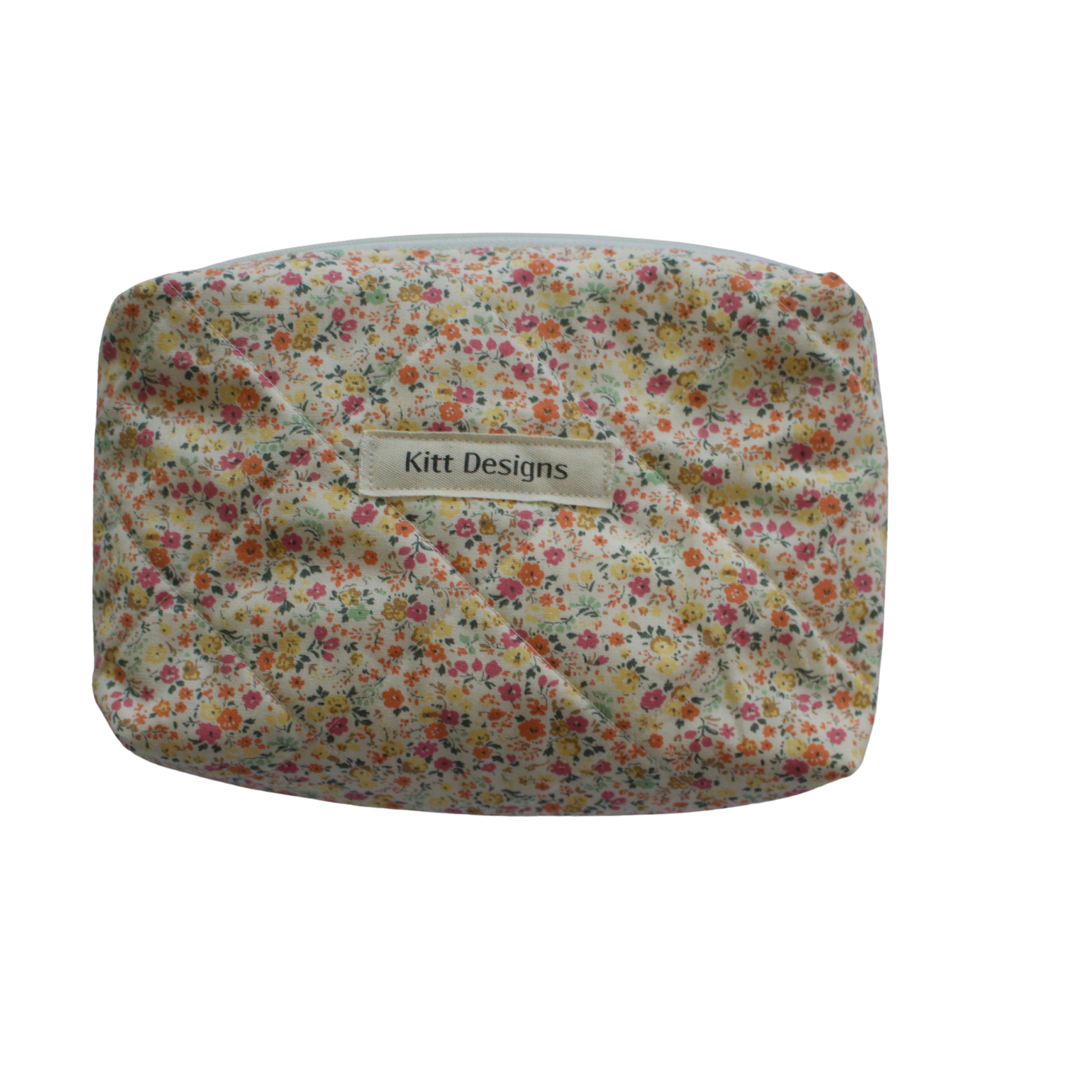 Floral patterned pouch with 'Kitt Designs' label on a white background mini pouch