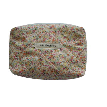 Floral patterned pouch with 'Kitt Designs' label on a white background mini pouch