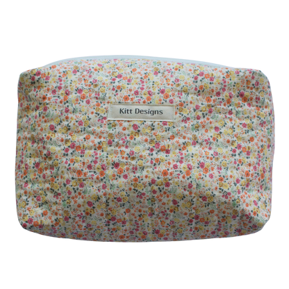 Floral-patterned pouch with 'Kitt Designs' beauty pouch